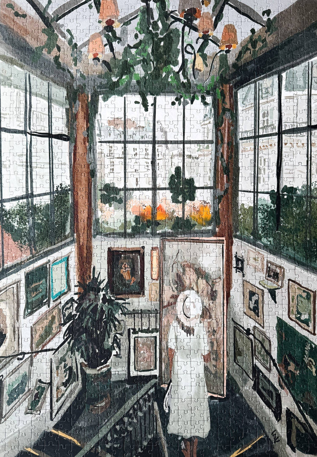 Art Gallery jigsaw puzzle featuring a woman in a room with large windows, plants and paintings.