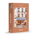 French Bistro 500-piece jigsaw puzzle by Piecely, featuring a street scene with a cozy restaurant and blue-and-white striped awnings. Ett charmigt pussel för vuxna med stadsmotiv.