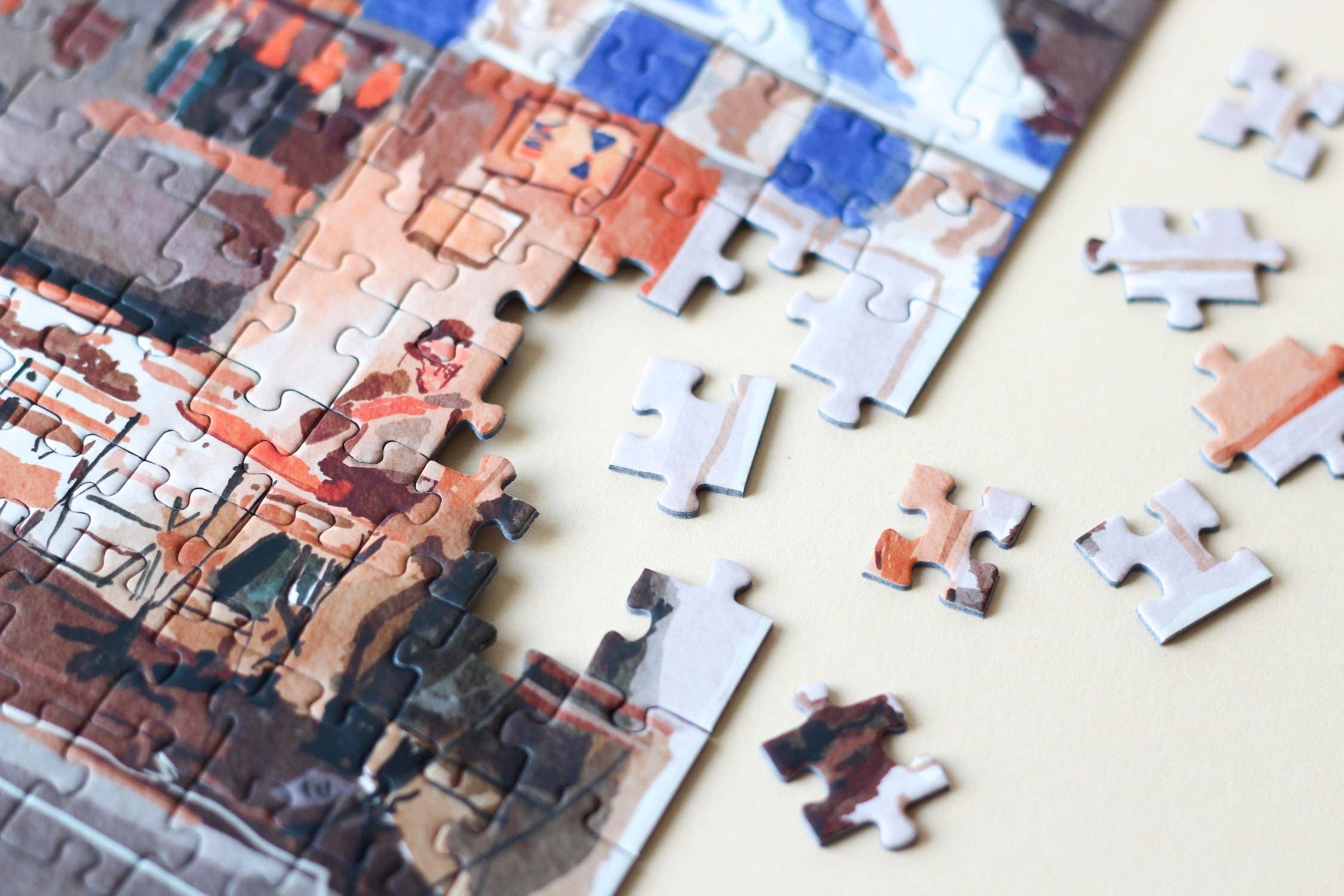 French Bistro jigsaw puzzle partially completed with edge close up.