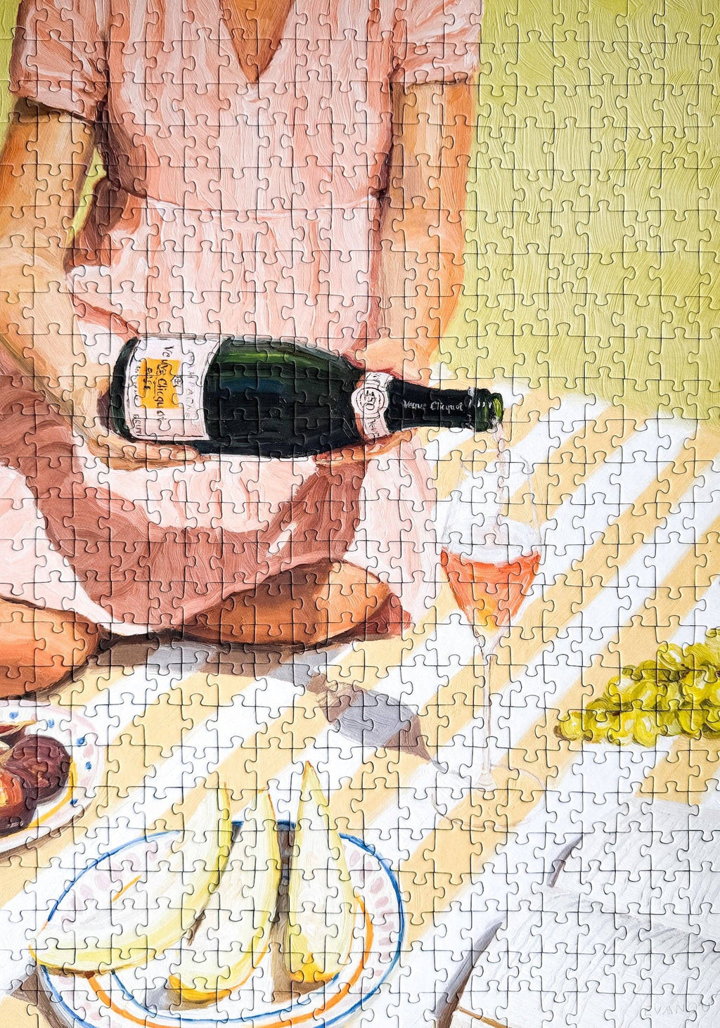 La Dolce Vita jigsaw puzzle completed featuring a person holding a bottle of wine at a picnic setting.