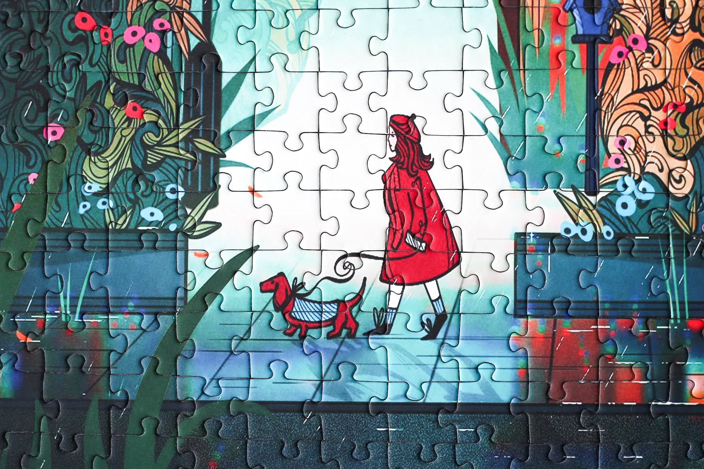 Midnight Walk jigsaw puzzle completed section featuring a woman dressed in red walking her dog.