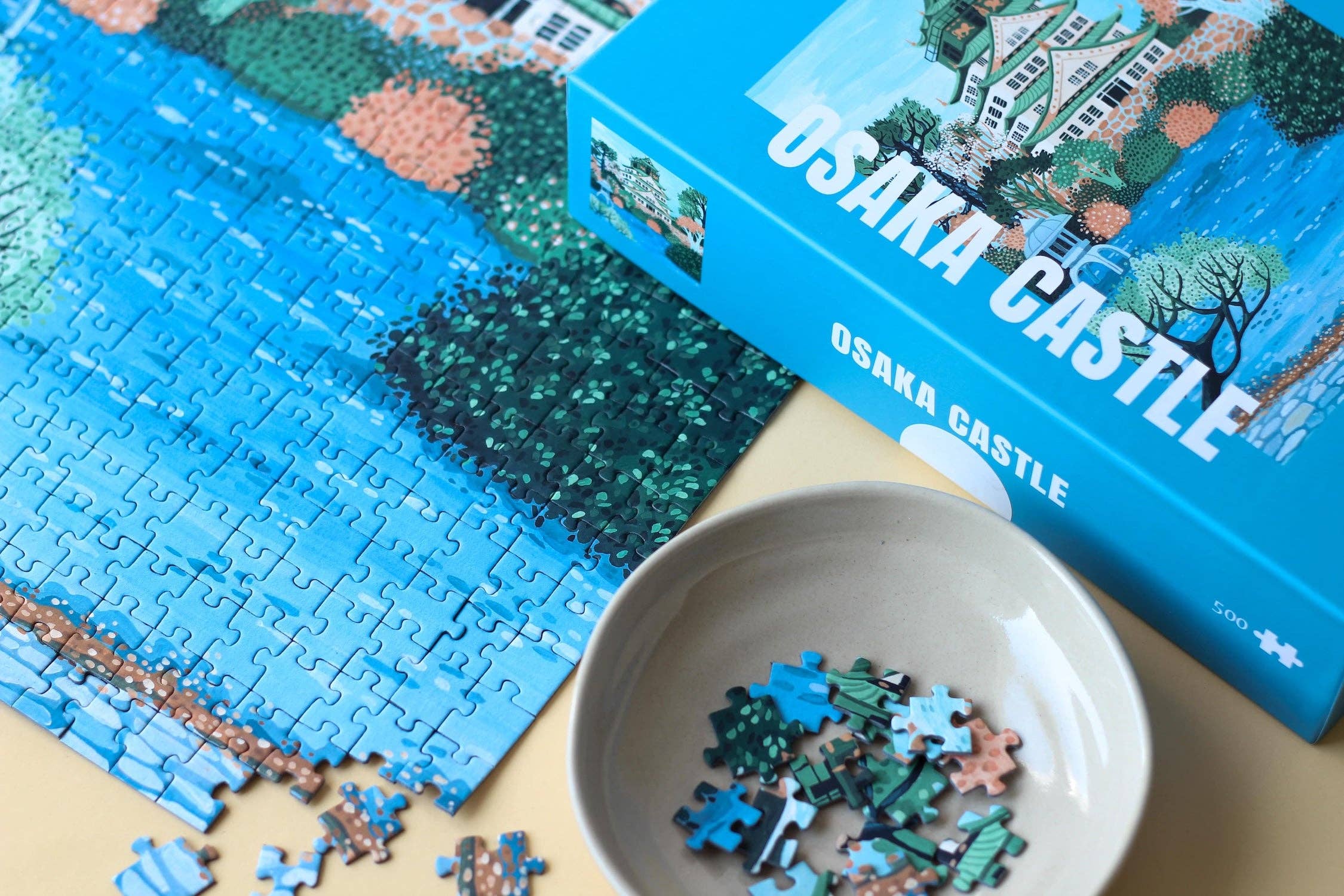Osaka Castle jigsaw puzzle partially completed next to a puzzle box.