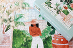Peaceful Morocco jigsaw puzzle completed section next to a puzzle box showing a woman in a garden.