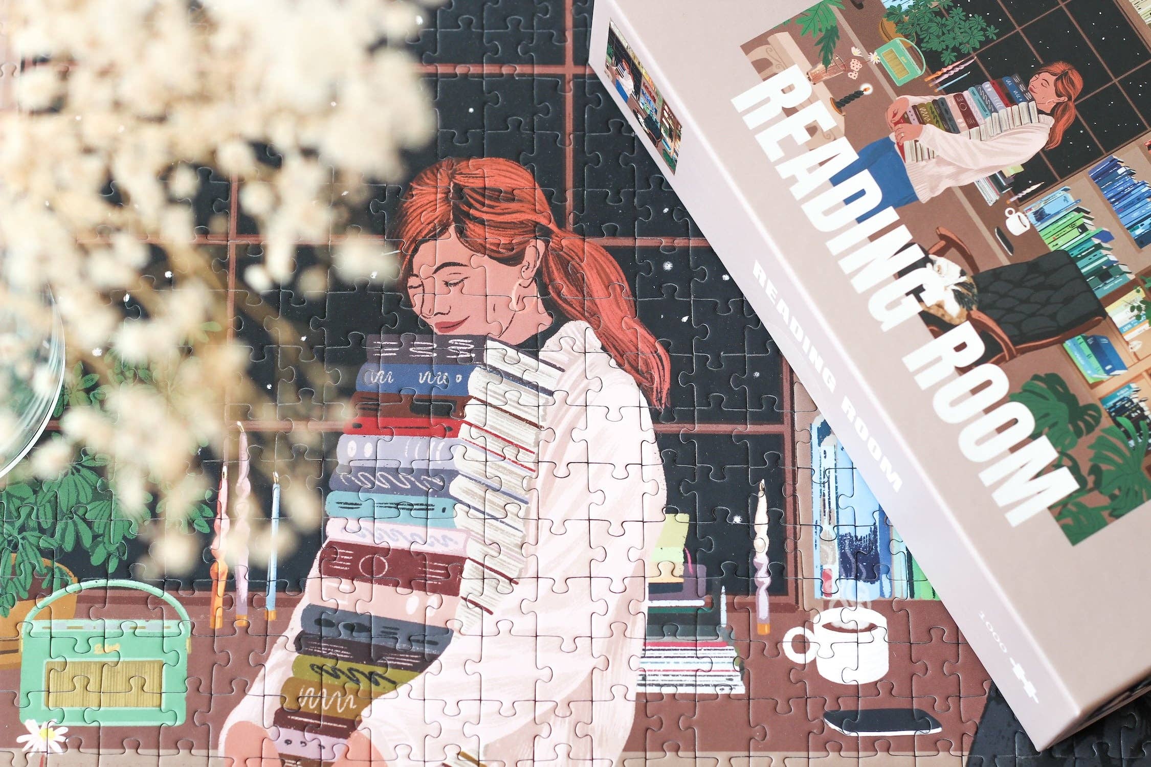 Reading Room jigsaw puzzle featuring a woman carrying books, partially completed, next to a puzzle box.