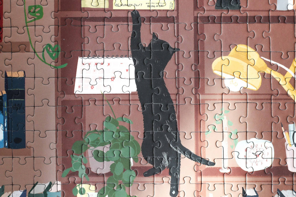 Reading Room jigsaw puzzle close up featuring a scene of a cat and books on a shelf.