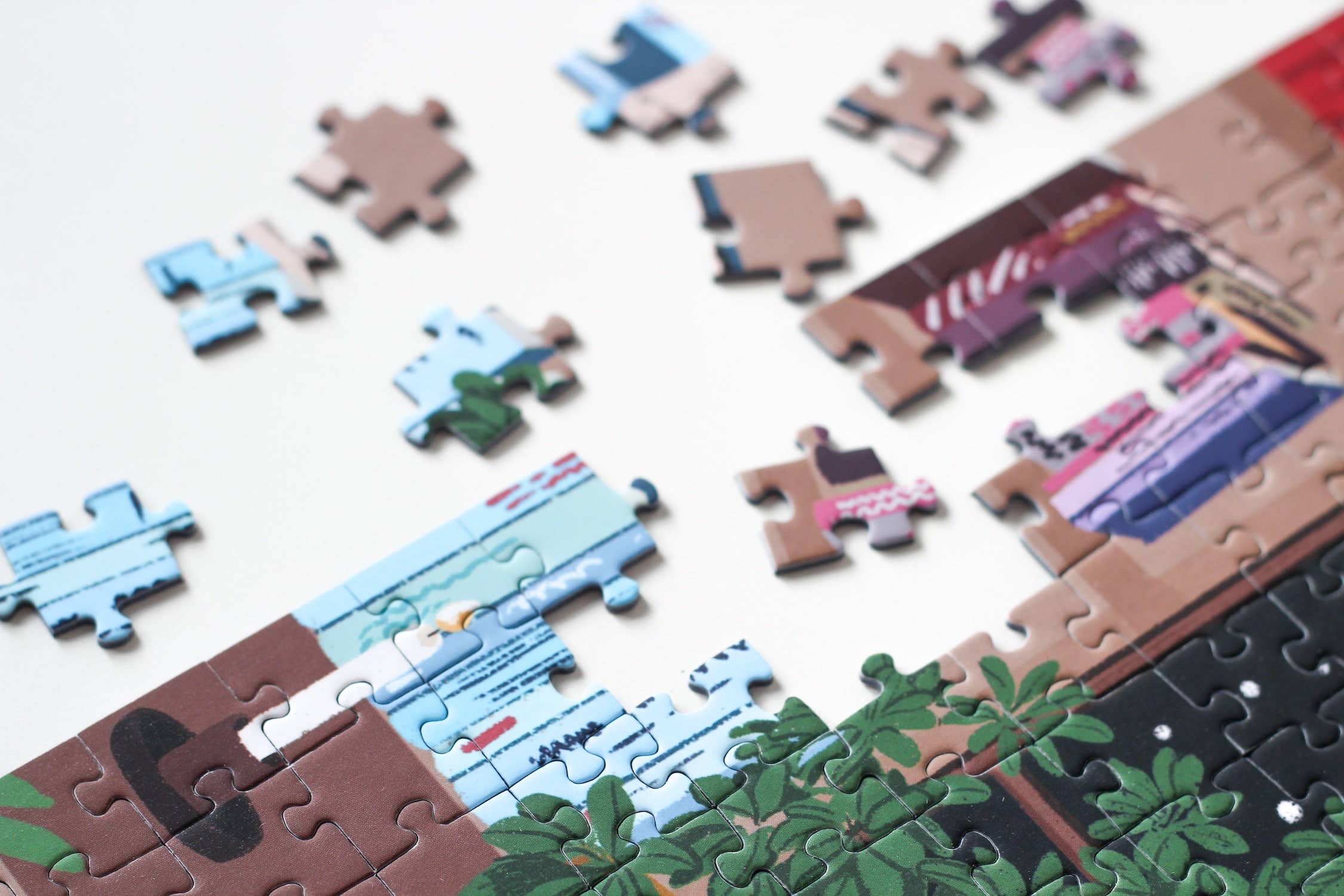 Reading Room jigsaw puzzle partially completed with close up on edge pieces.