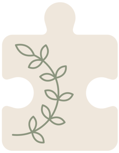 Beige puzzle piece with green leaf design inside.