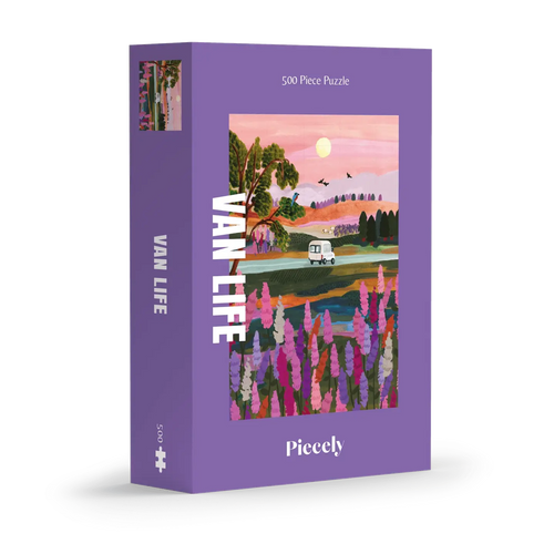 Van Life 500-piece jigsaw puzzle by Piecely, featuring a camper van driving through a scenic landscape at sunset with blooming flowers in the foreground. Ett pussel för vuxna med tema resor och äventyr.