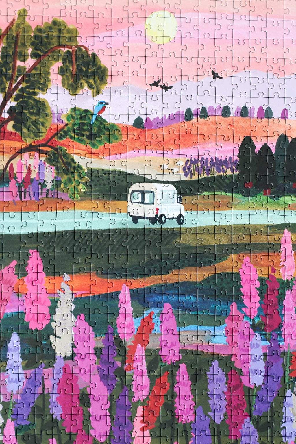 Van Life jigsaw puzzle completed featuring a van on the road, with trees and flowers.