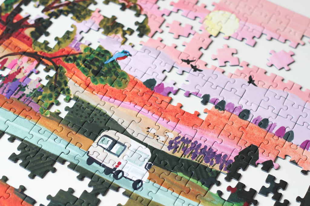 Van Life jigsaw puzzle partially completed featuring a colorful landscape design with a camper van.